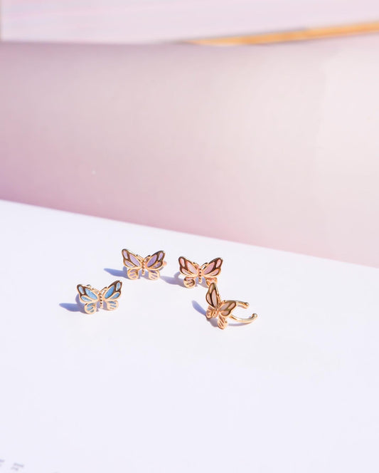 Butterfly-shaped earrings on a light pink and white background