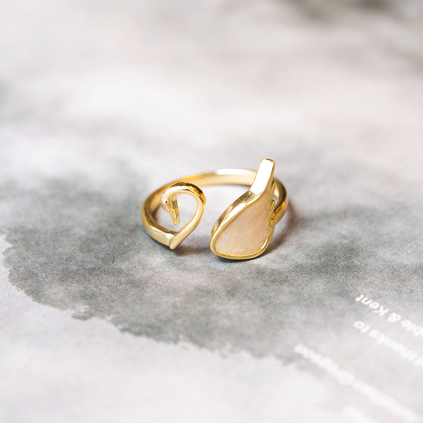 Gold ring with a unique design on a gray surface