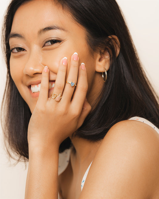 Woman with jewelry on her hand and smiling