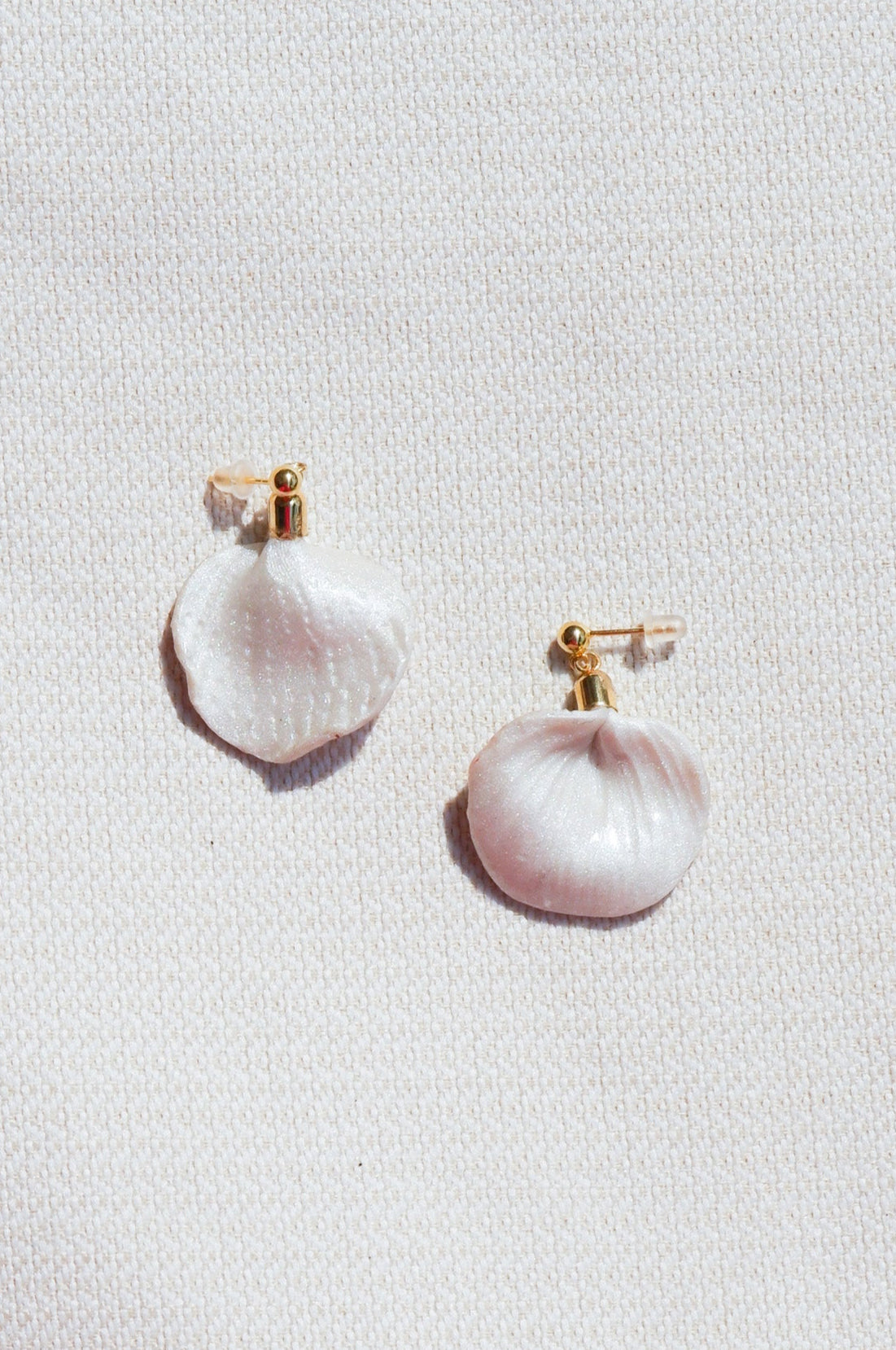 Pair of pearl earrings on a light gray background