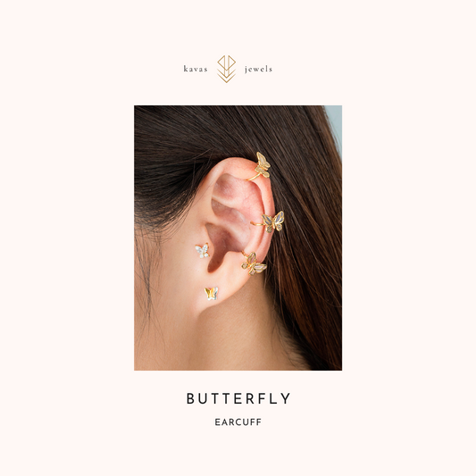 Butterfly ear cuff worn on an ear with 'kavas jewels' branding.