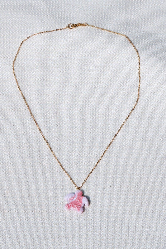 Necklace with a pink turtle pendant