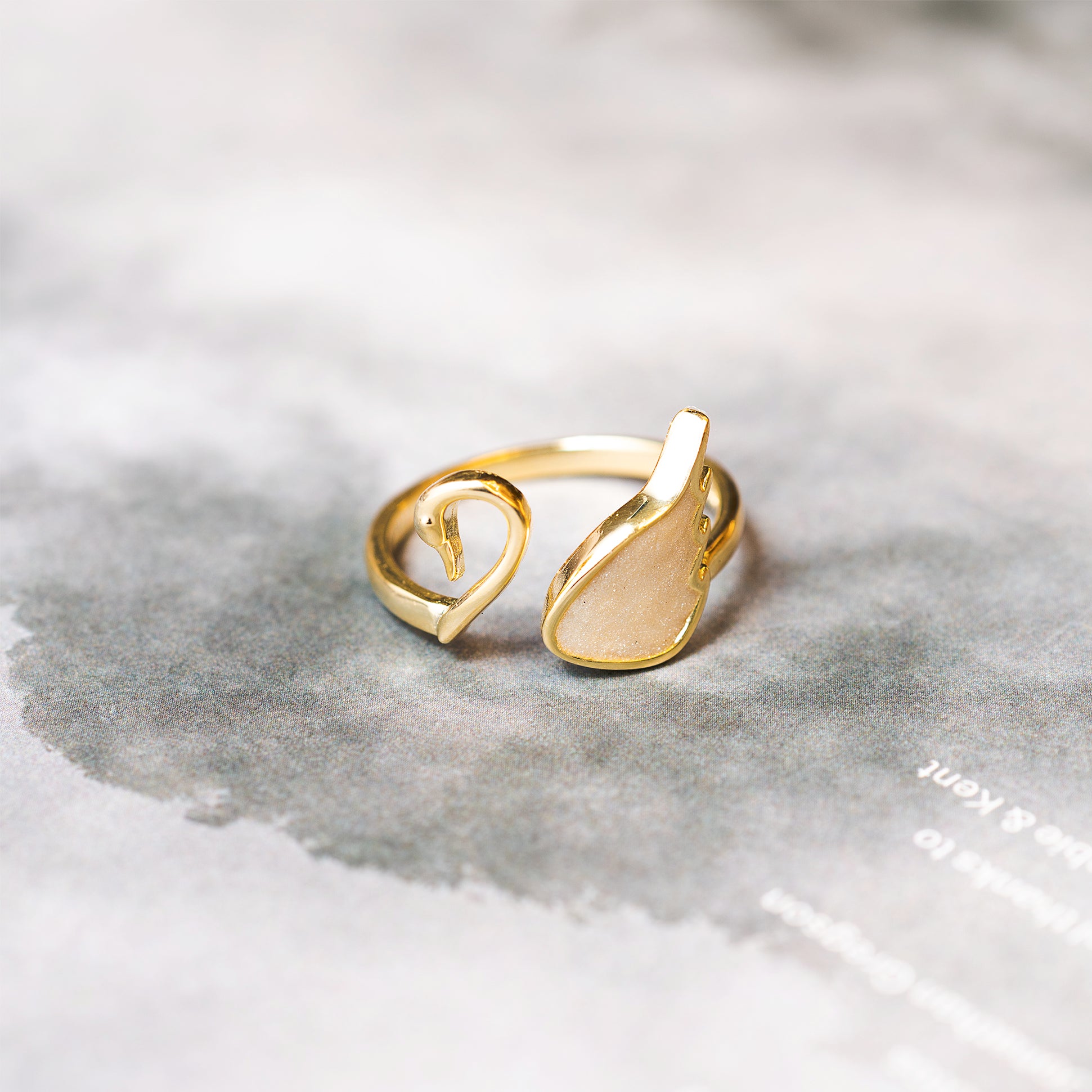 Gold ring with a unique design on a gray surface